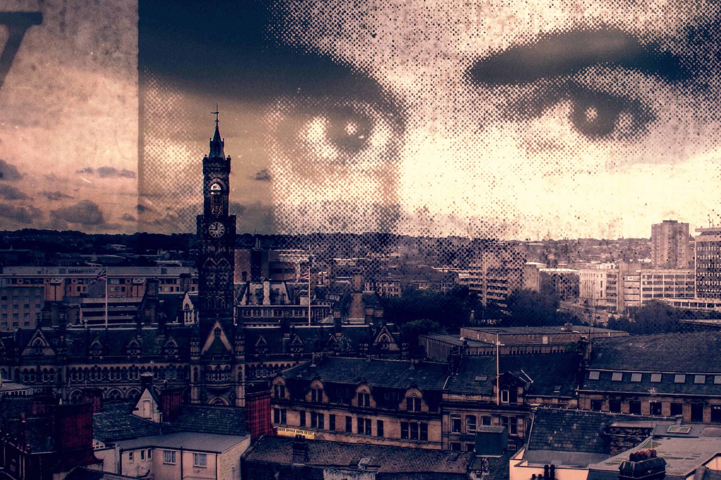 Man's eyes overlayed on a landscape view of a city