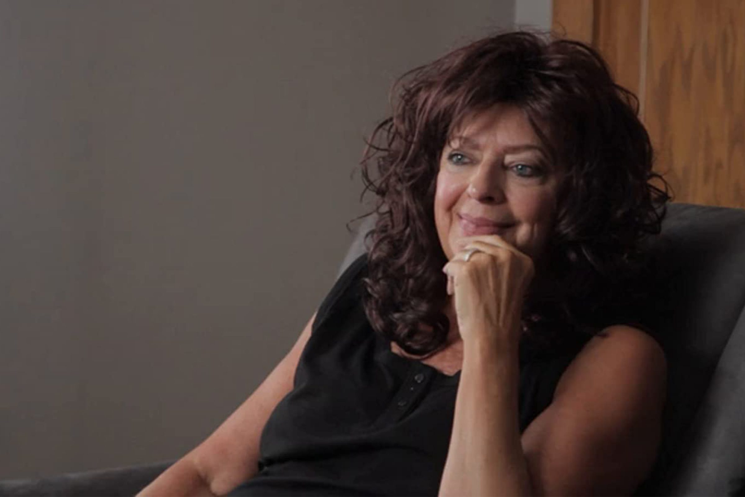 woman sitting in office chair being interviewed