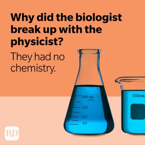 Beakers with blue liquid on orange background