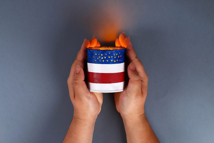 Diy 4th of July tin can candlestick, electric tape, paint color American flag, red, blue, white.