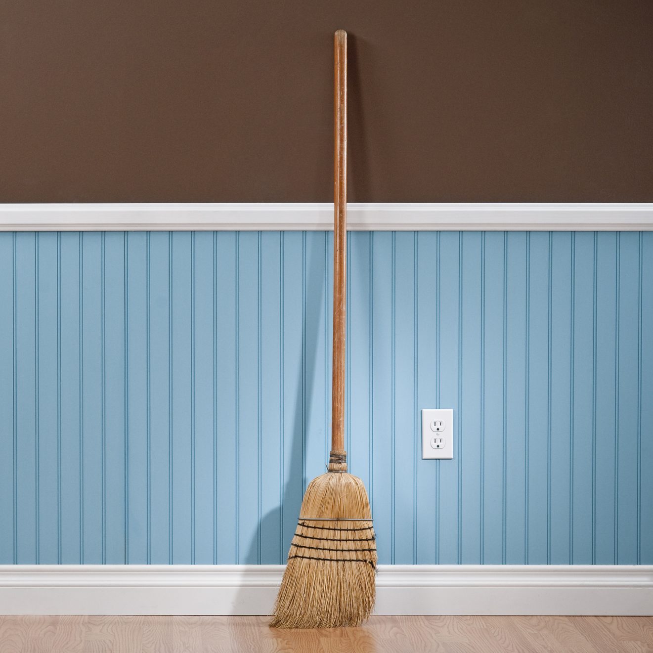 Corn whisk broom standing in empty room
