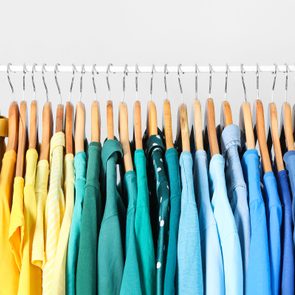 rack of clothes organized by color