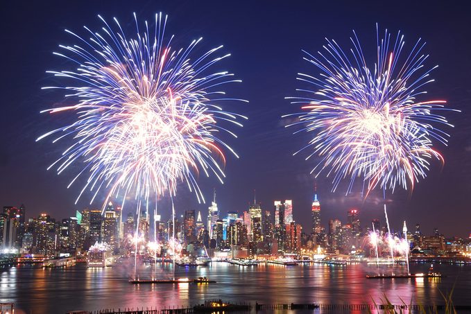 New York City Manhattan July 4th Independence day fireworks show with skyline over Hudson River viewed from New Jersey