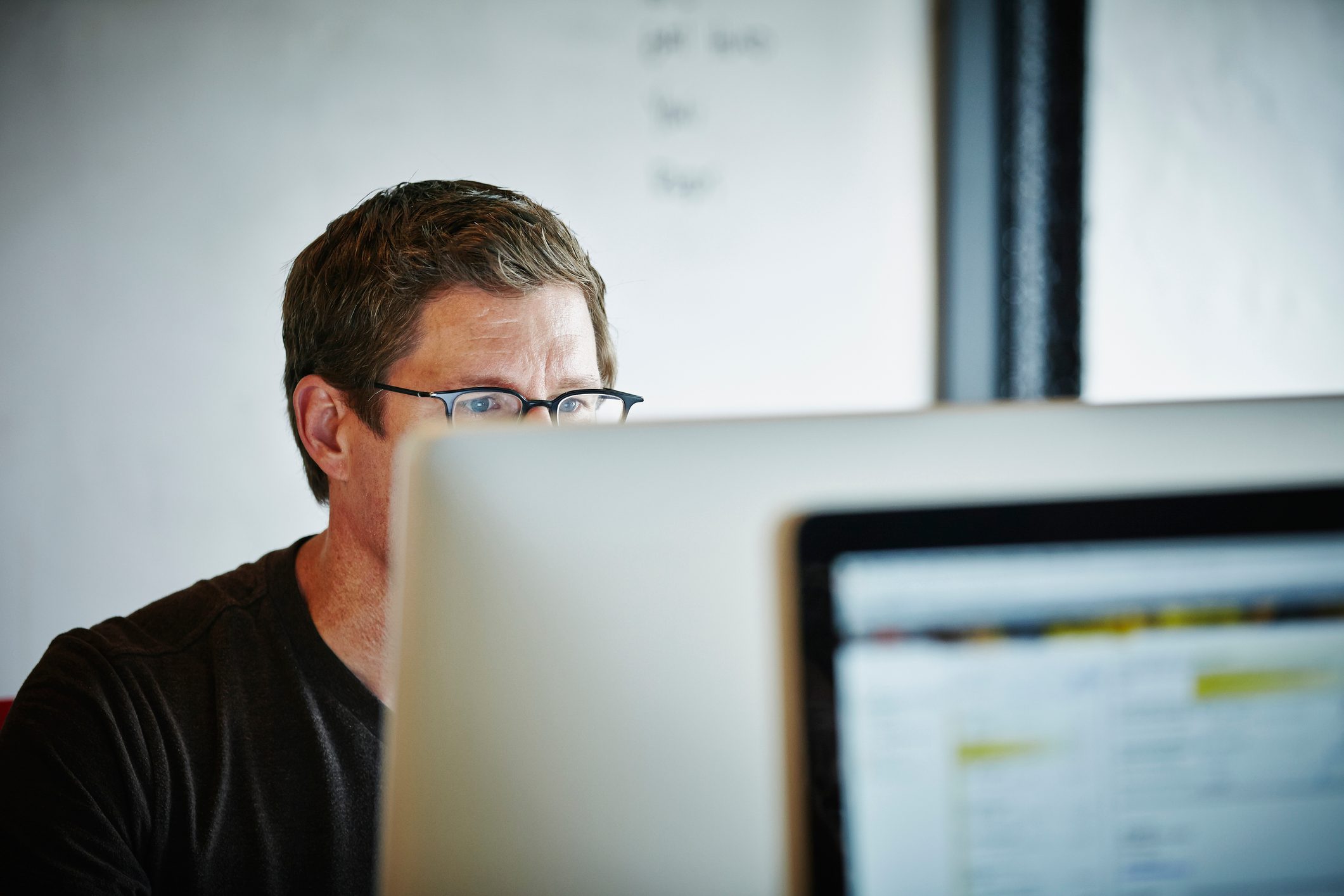 Businessman sitting at desk working on computer