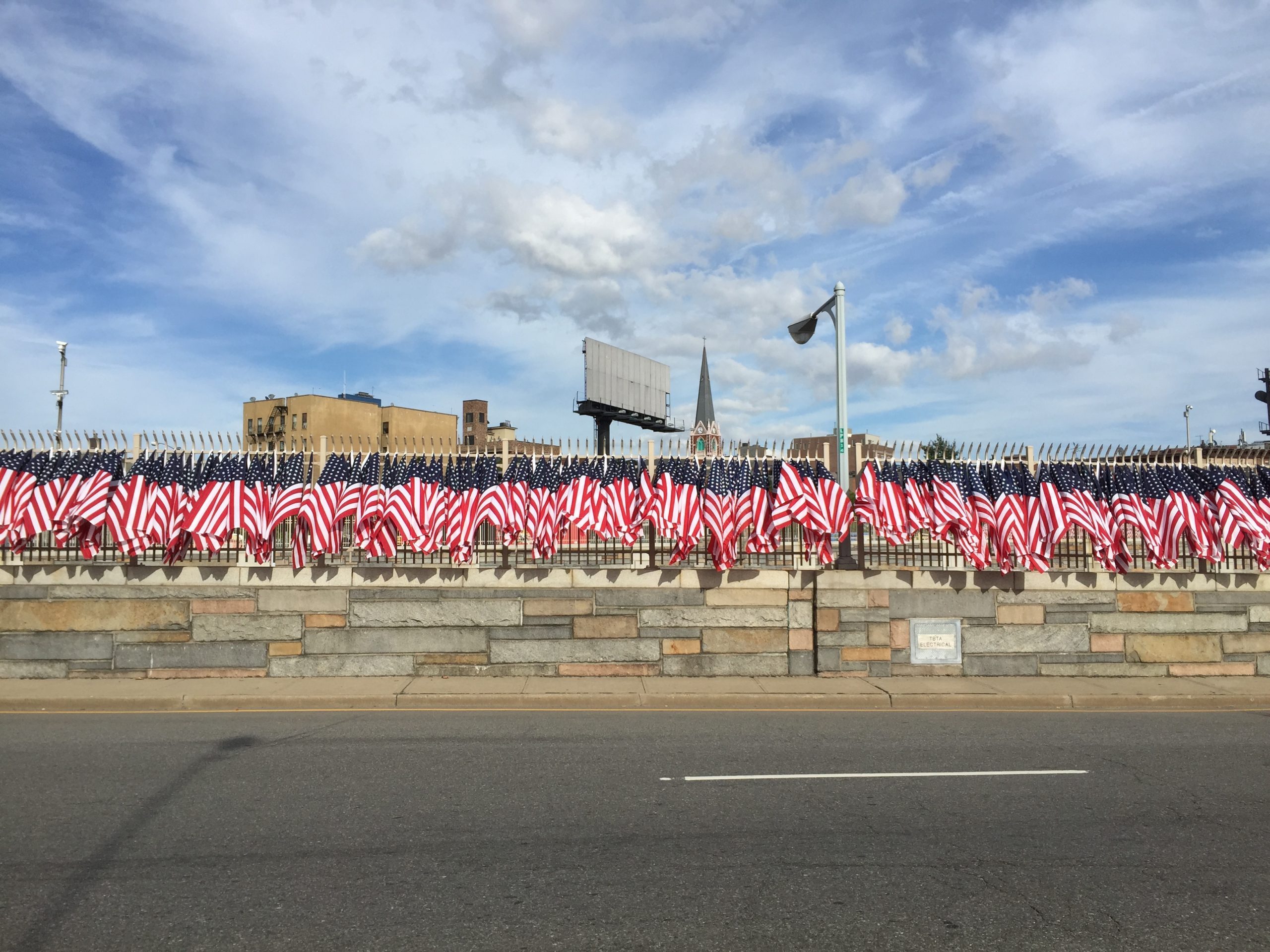 american flags line the side of a road for a running event in new york city