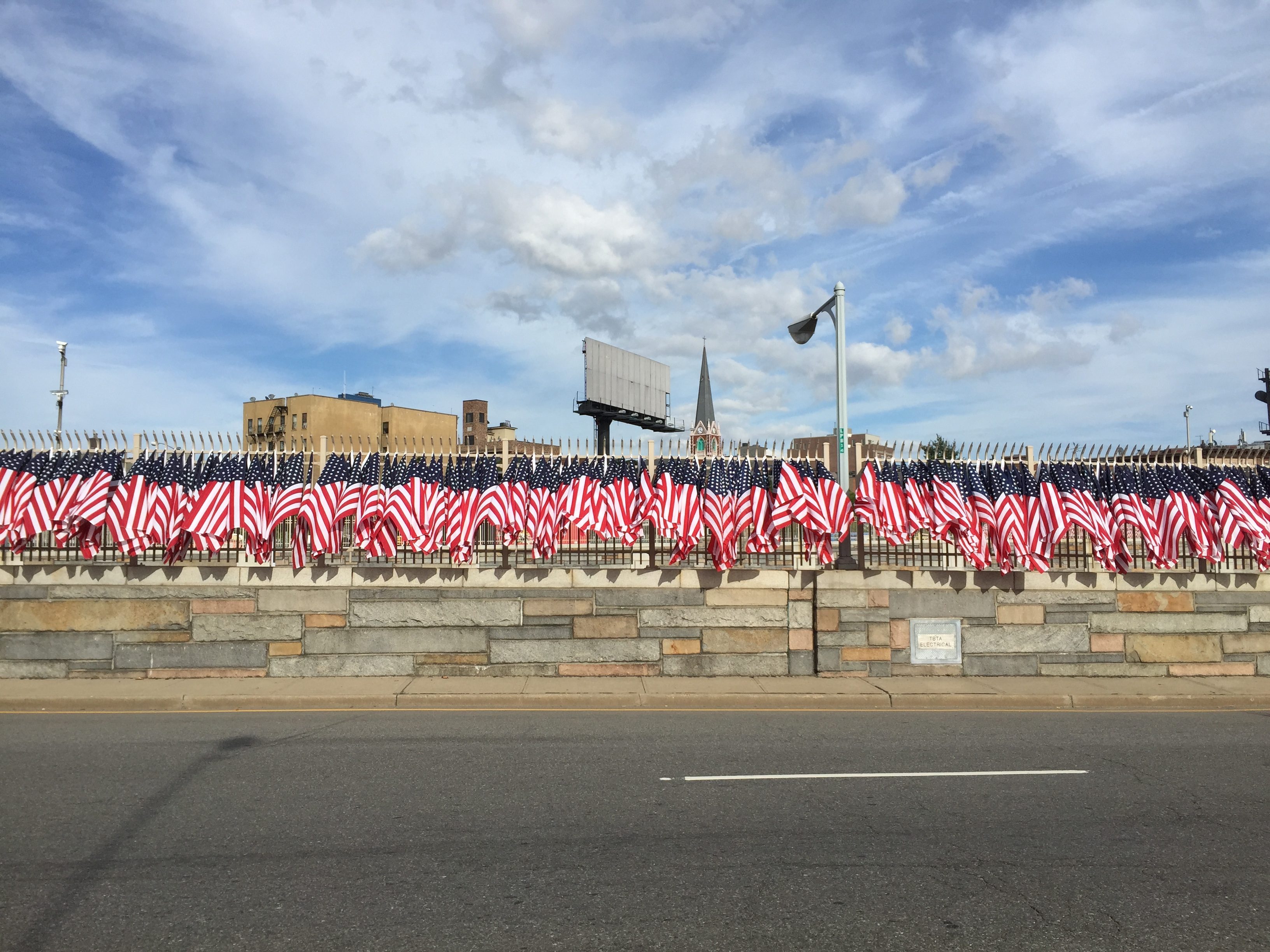 american flags line the side of a road for a running event in new york city
