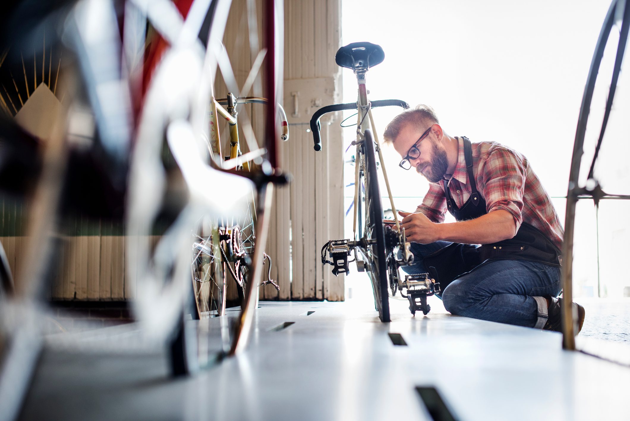 A man working in a bicycle repair shop.