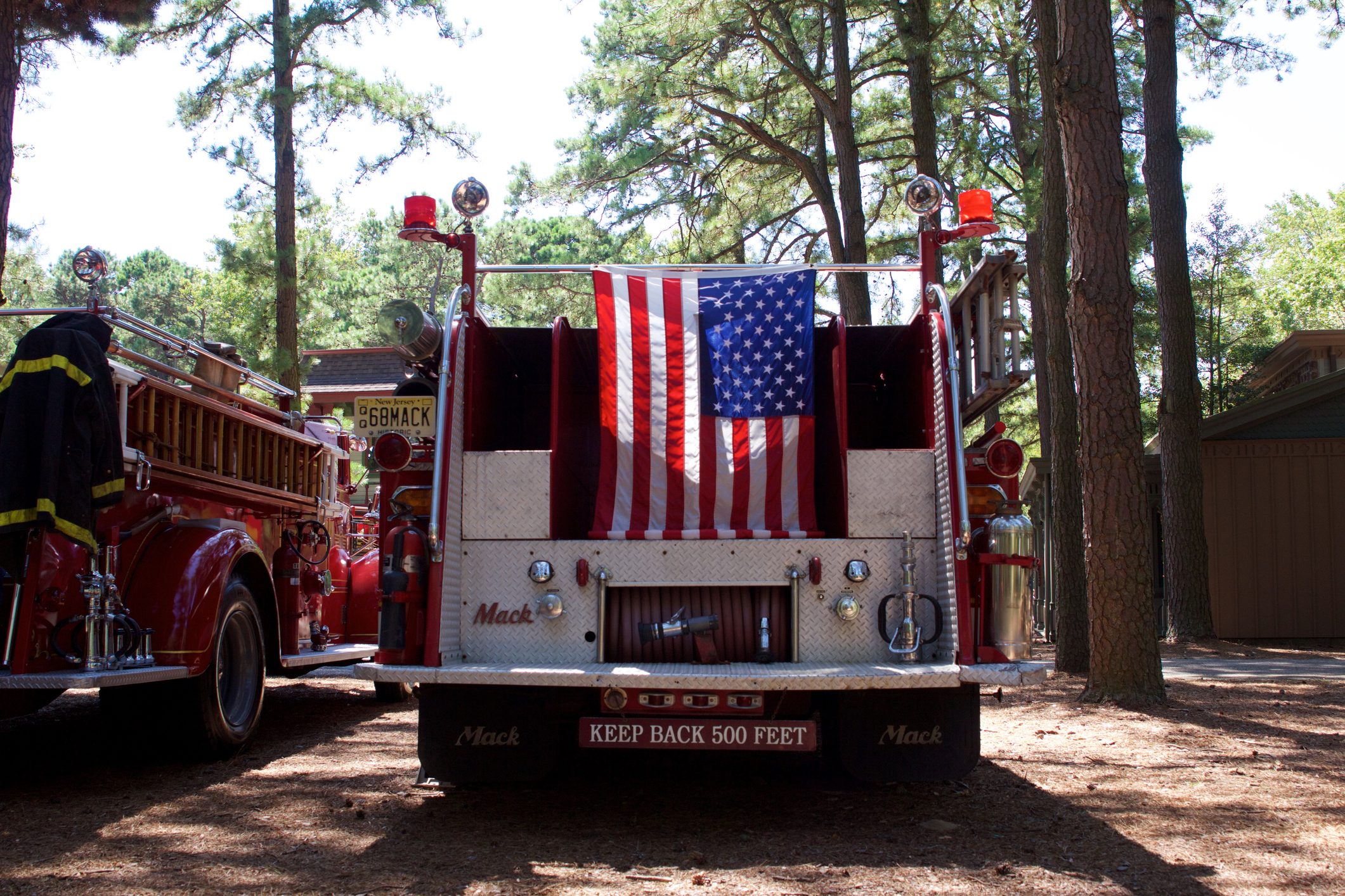 American flag hanging from the back of a vintage Mack fire truck in Millville, New Jersey