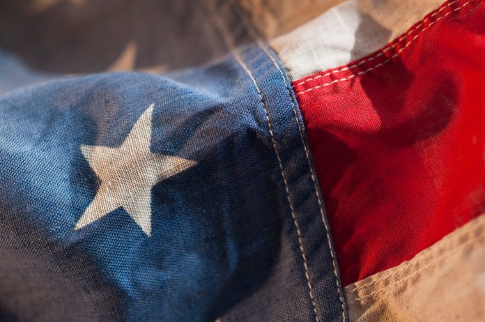 close of detail showing the texture of the fabric of an american flag