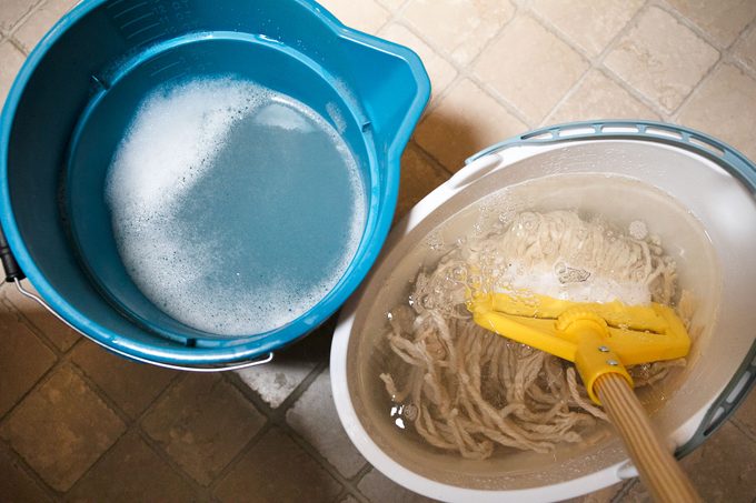 rinsing mop while mopping the bathroom floor
