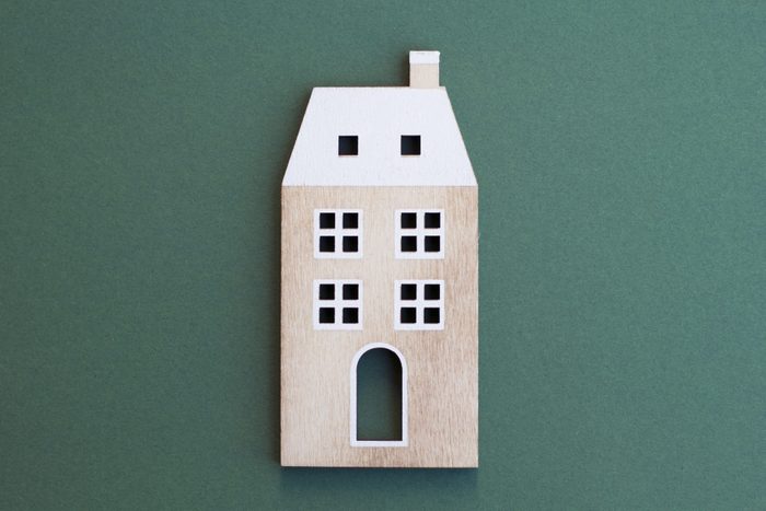 wooden apartment building on green background