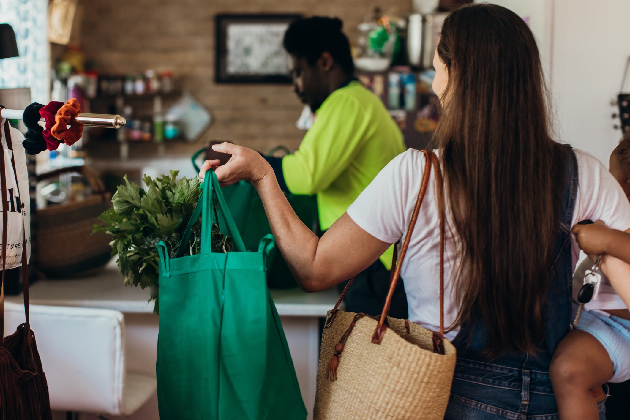 family bringing in the groceries to their kitchen in reusable bags