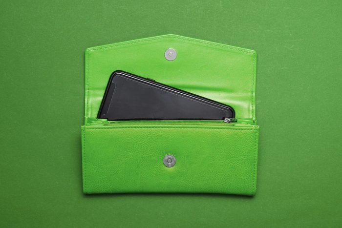 smartphone popping out of open wallet