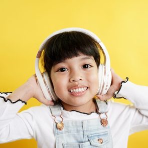 happy child listening to a podcast