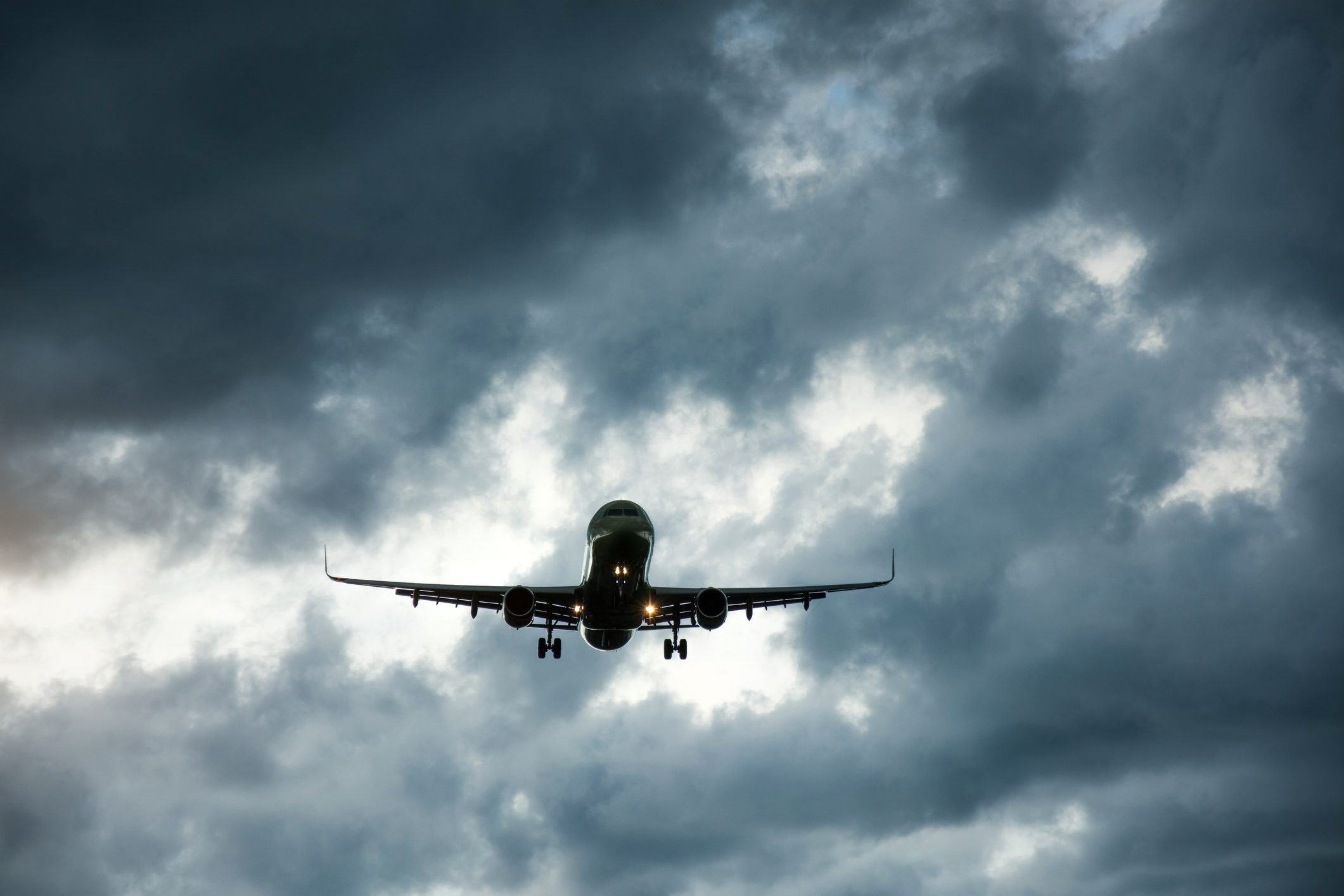 The heavy storm is approaching the airport in cloudy weather.