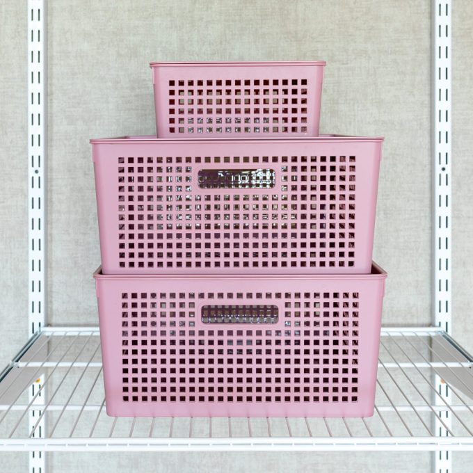 wire closet organizer shelf with stack of plasic bins