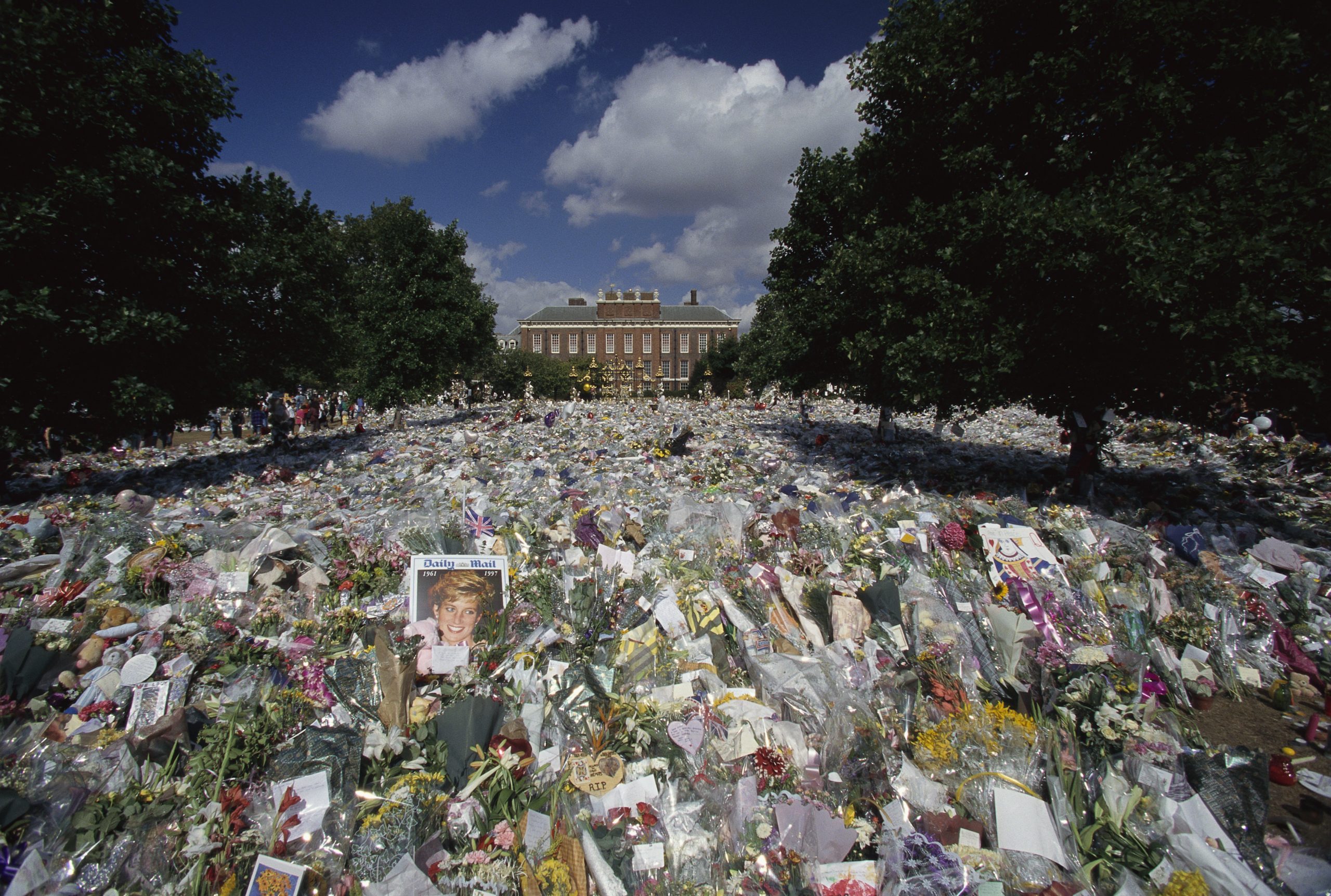 Mourners left dozens of bouquets, cards, and photographs outside Kensington Palace for the funeral of Diana, Princess of Wales