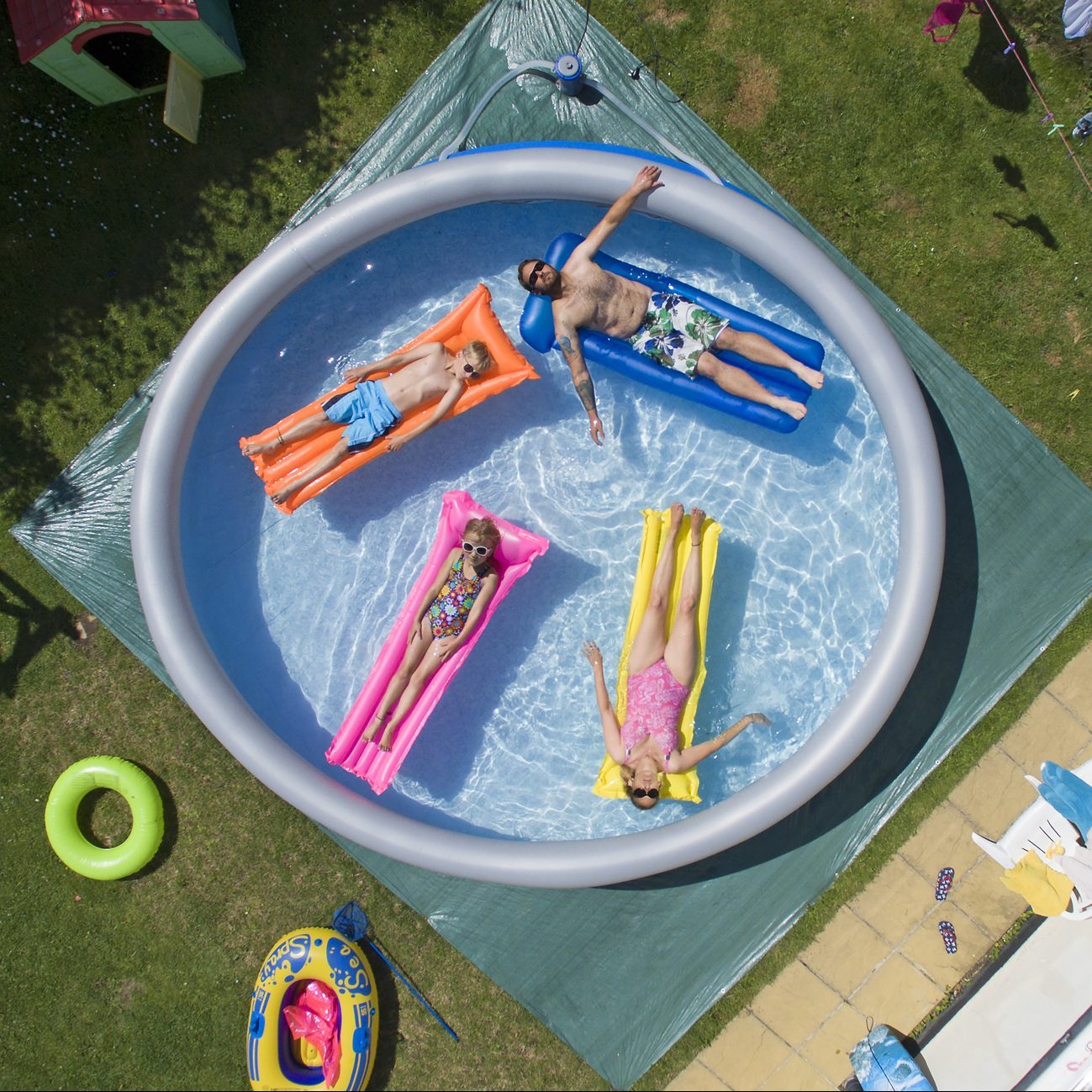 Family enjoying an inflatable pool in the summer time