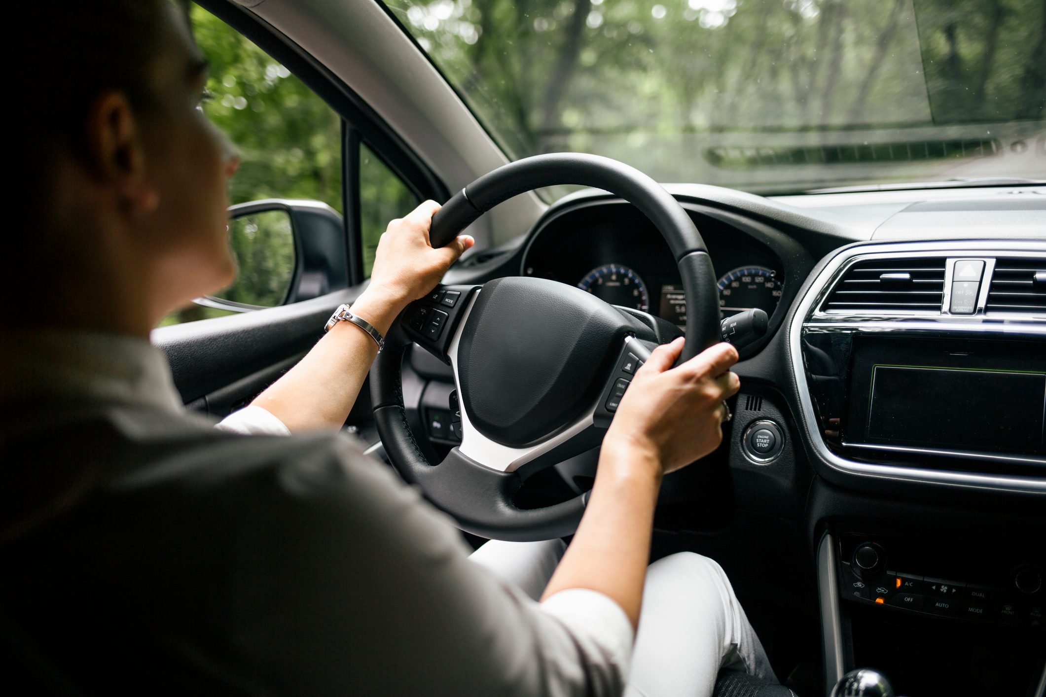 Back view of woman driving car