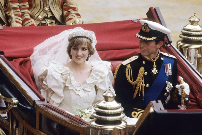 Prince Charles, Prince of Wales and Diana, Princess of Wales, wearing a wedding dress designed by David and Elizabeth Emanuel and the Spencer family Tiara, ride in an open carriage, from St. Paul's Cathedral to Buckingham Palace, following their wedding on July 29, 1981 in London, England.