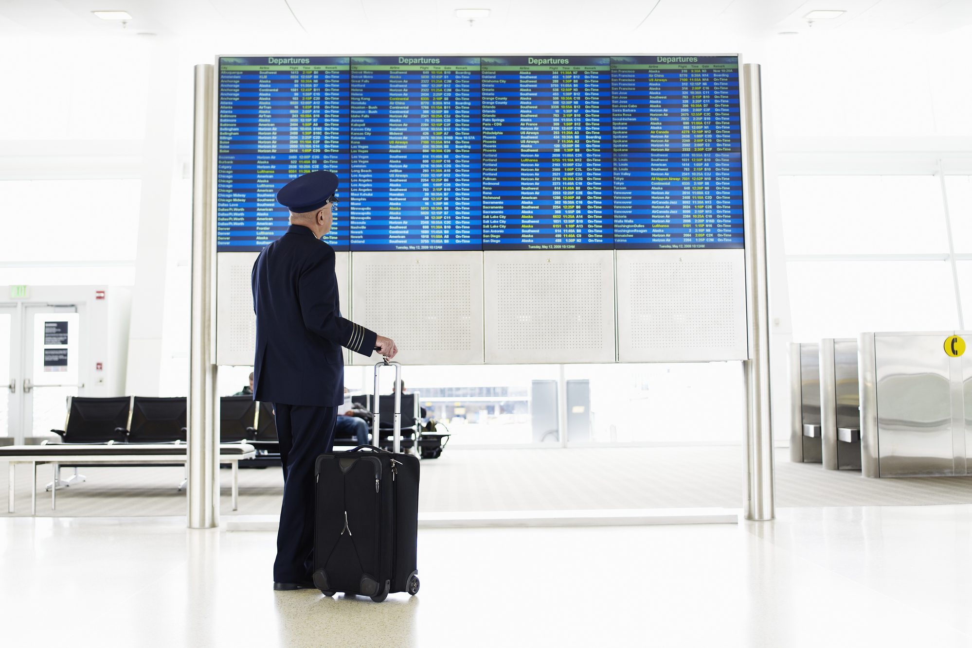 Pilot standing and looking at departure board