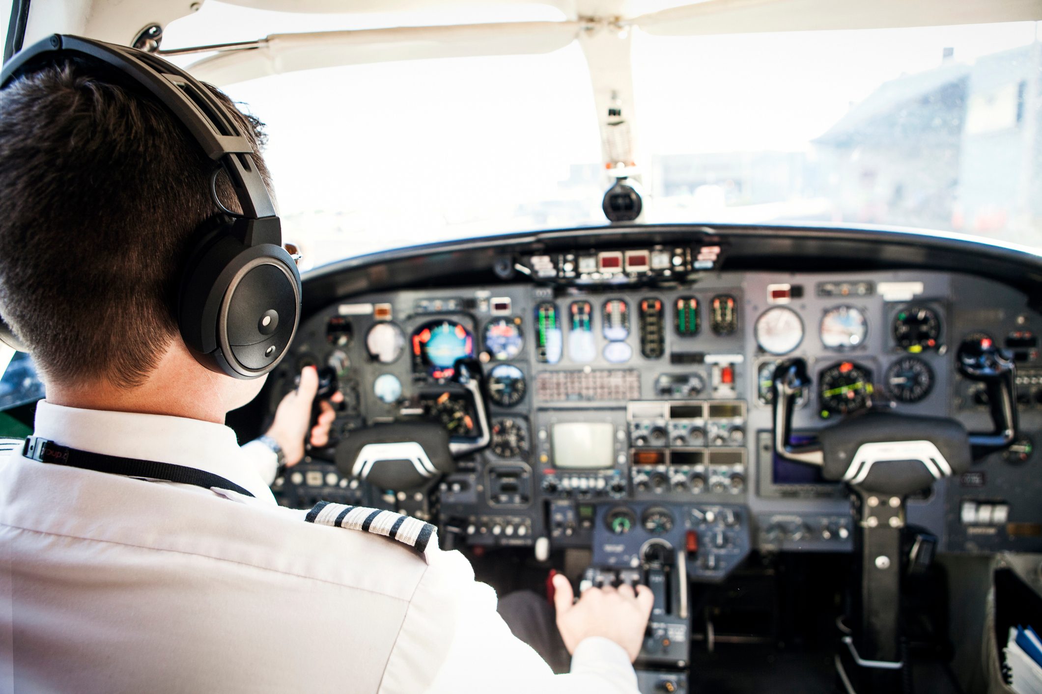 Rear view of pilot driving airplane