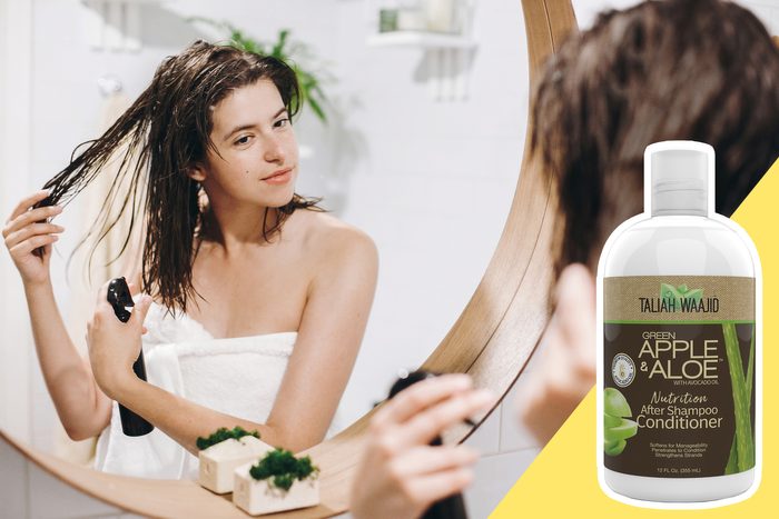 woman applying leave in conditioner spray