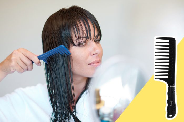 woman combing leave in conditioner through her hair