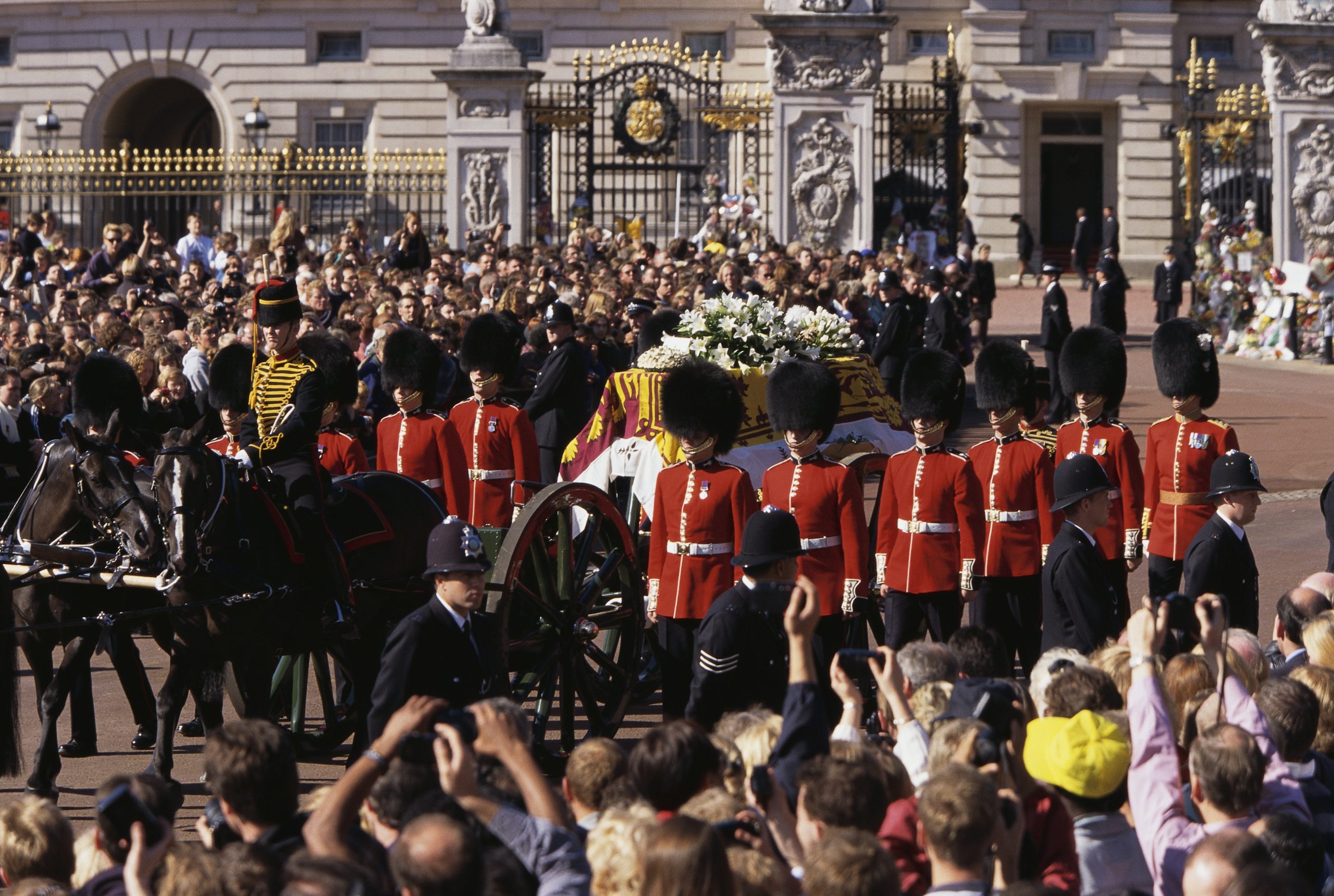 Mourners watch as the Queen's Life Guard escorts the coffin of Diana, Princess of Wales outside Buckingham Palace during her funeral