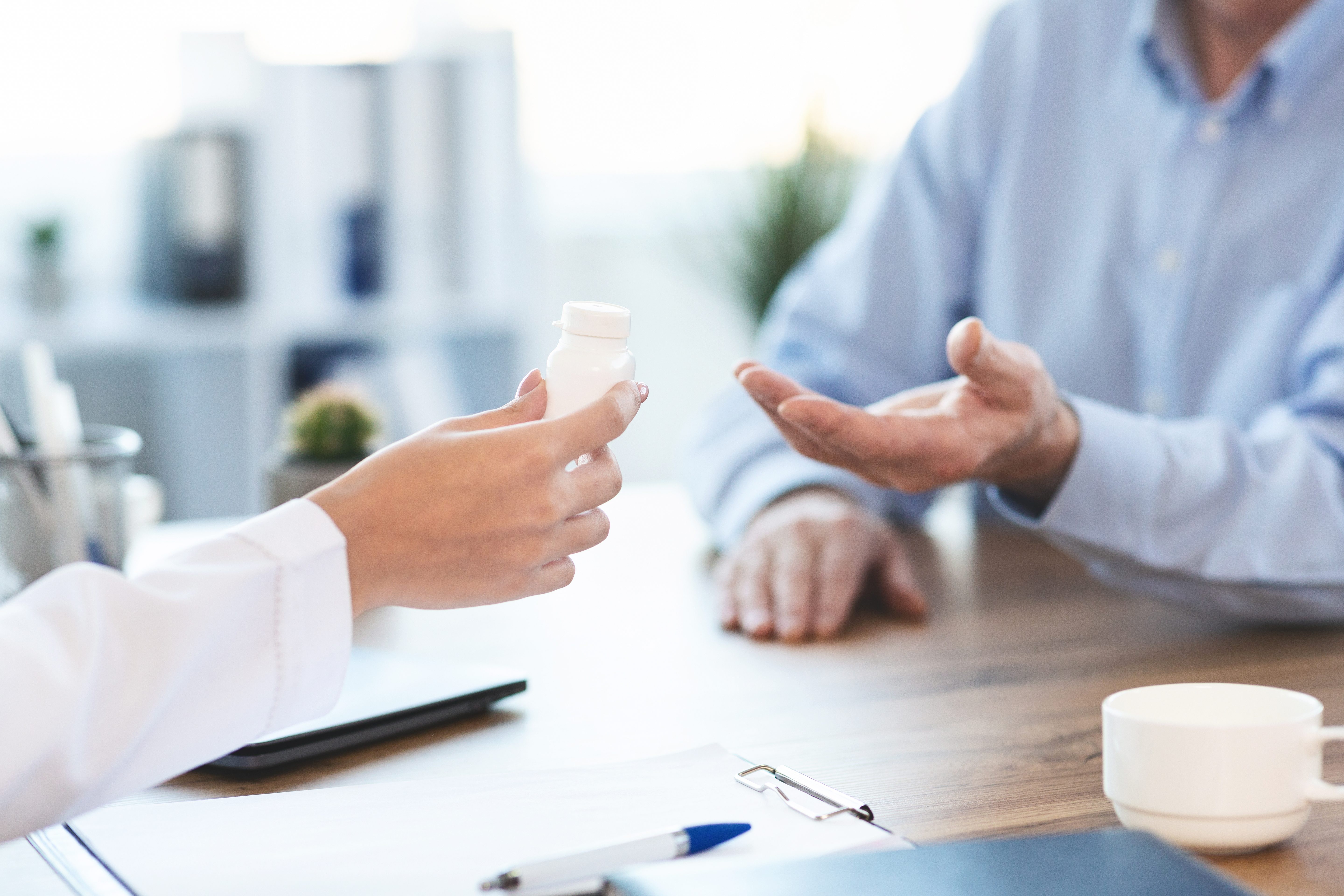 Medicine Concept. Close up of doctor giving medication pill bottle to retired man, copy space; Shutterstock ID 1591201198; Use (Print or Web): -; Client/Licensee: -