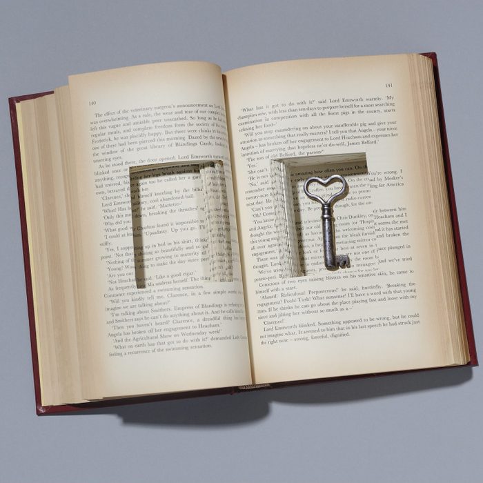 Book with key in cut out compartment.