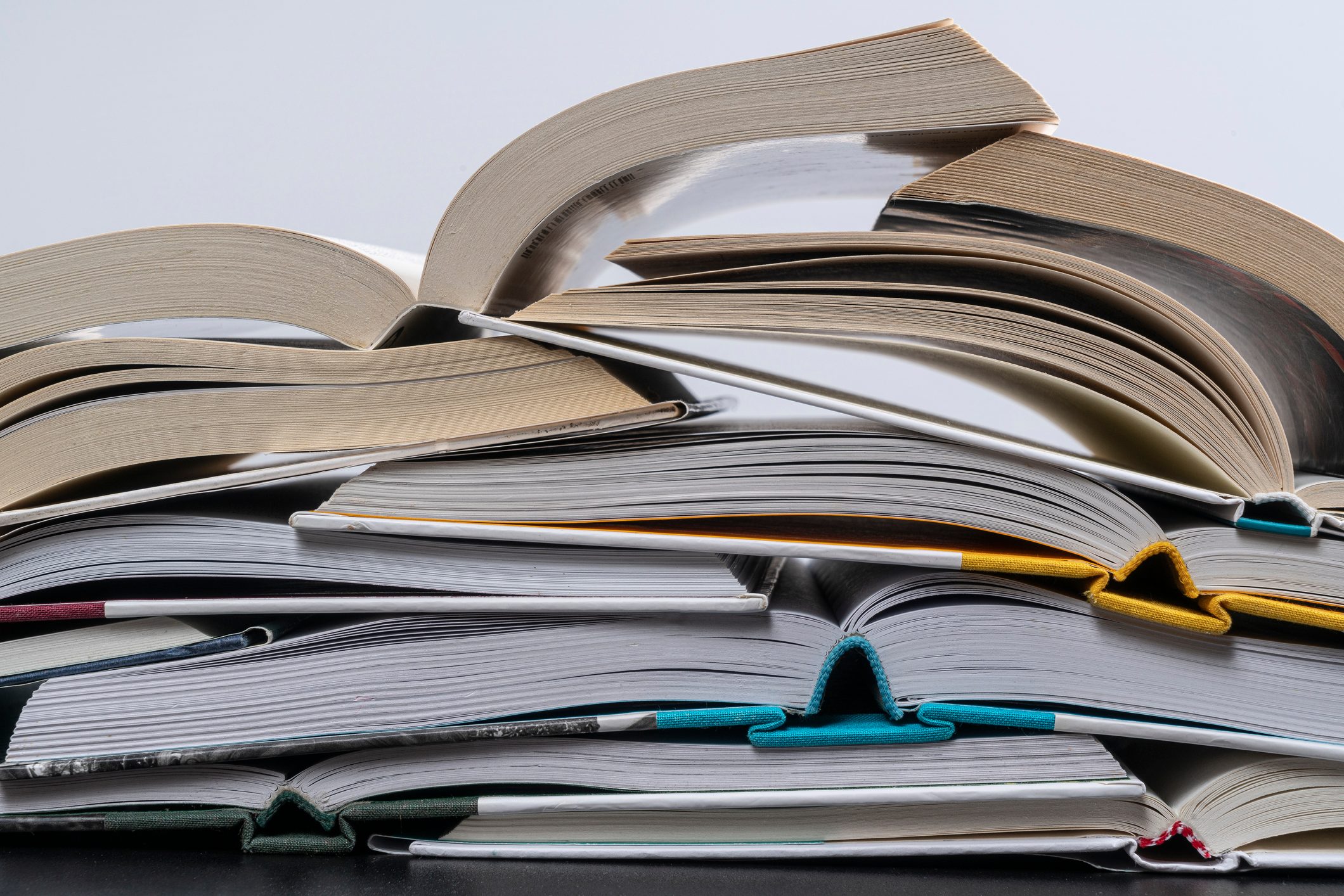 Stack Of Open Books On Table