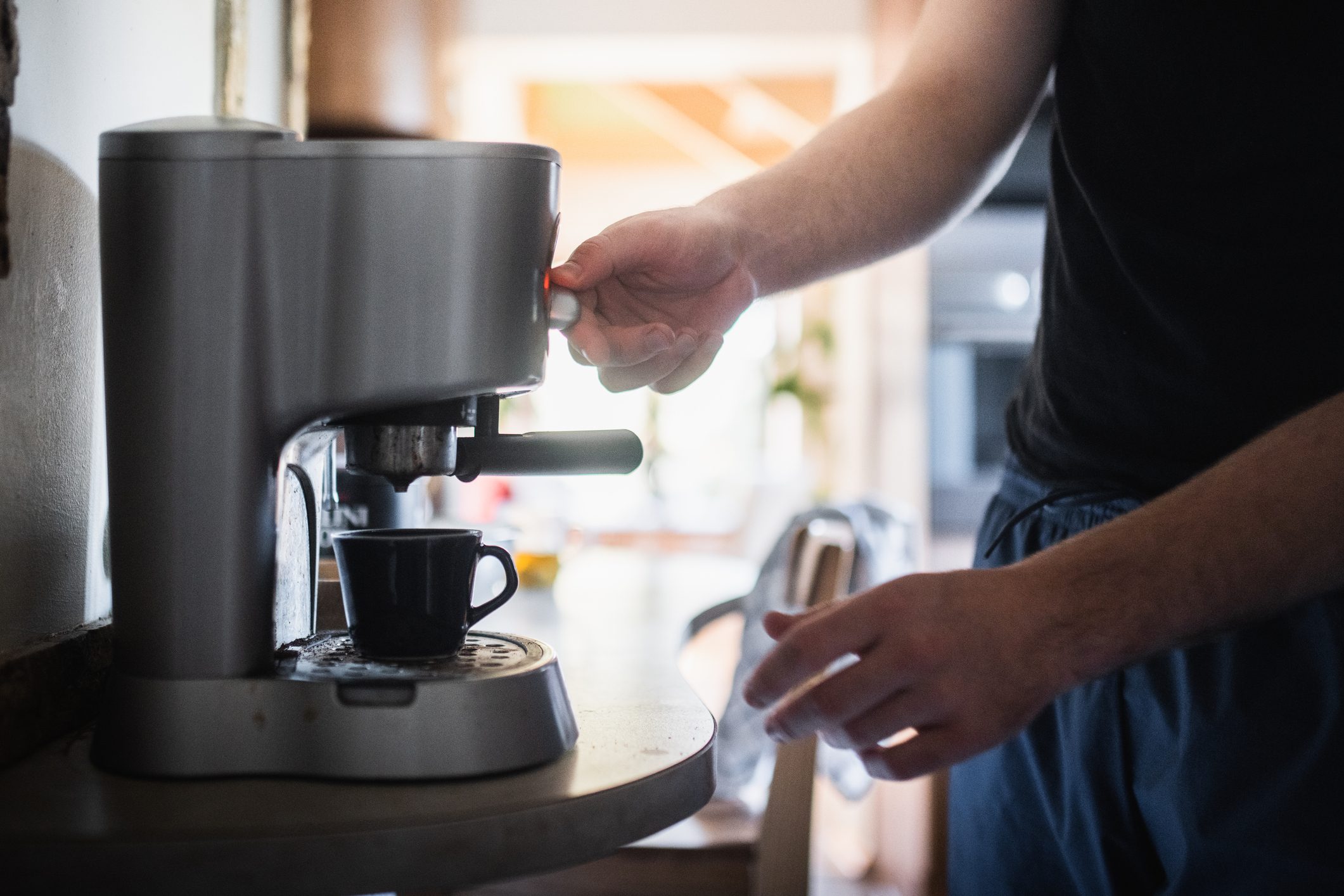 Midsection of man preparing coffee at home,Poland