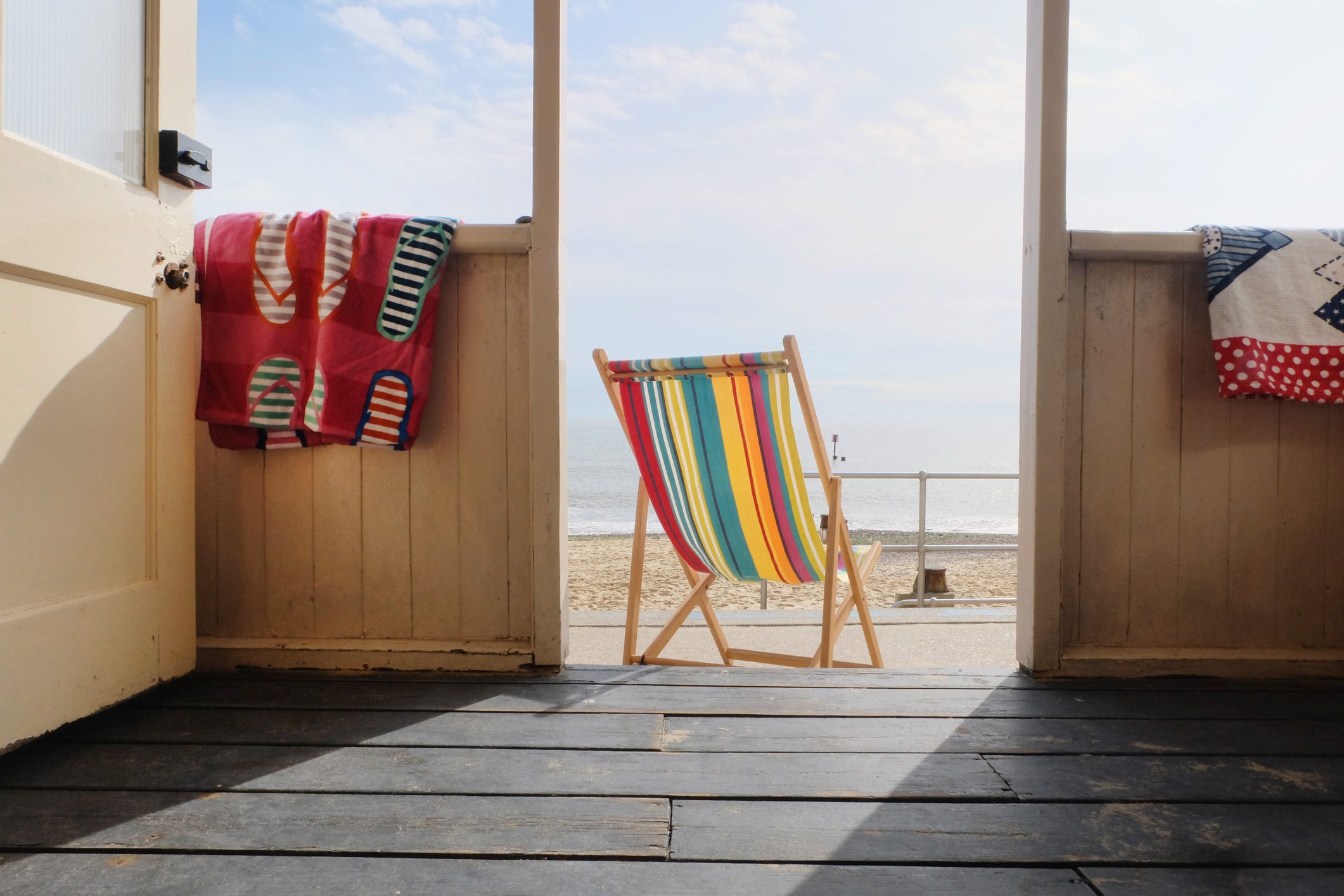 Empty deckchair outside beach hut, rear view
