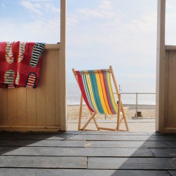 Empty deckchair outside beach hut, rear view