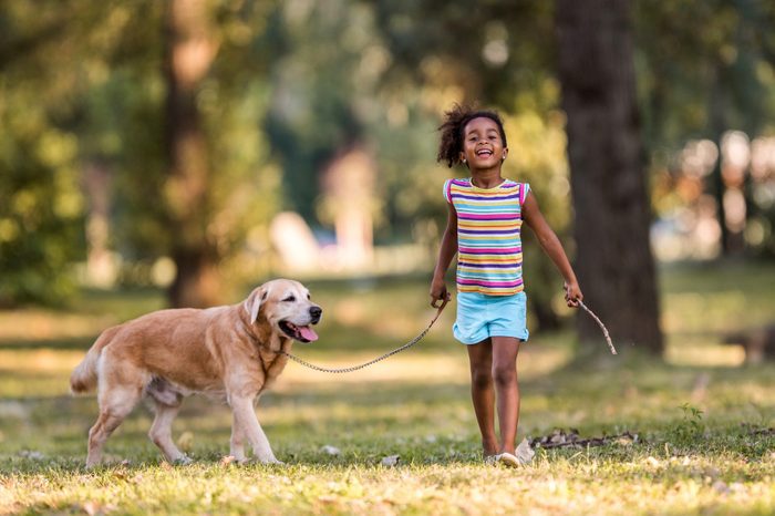 young girl with her labrador retriever