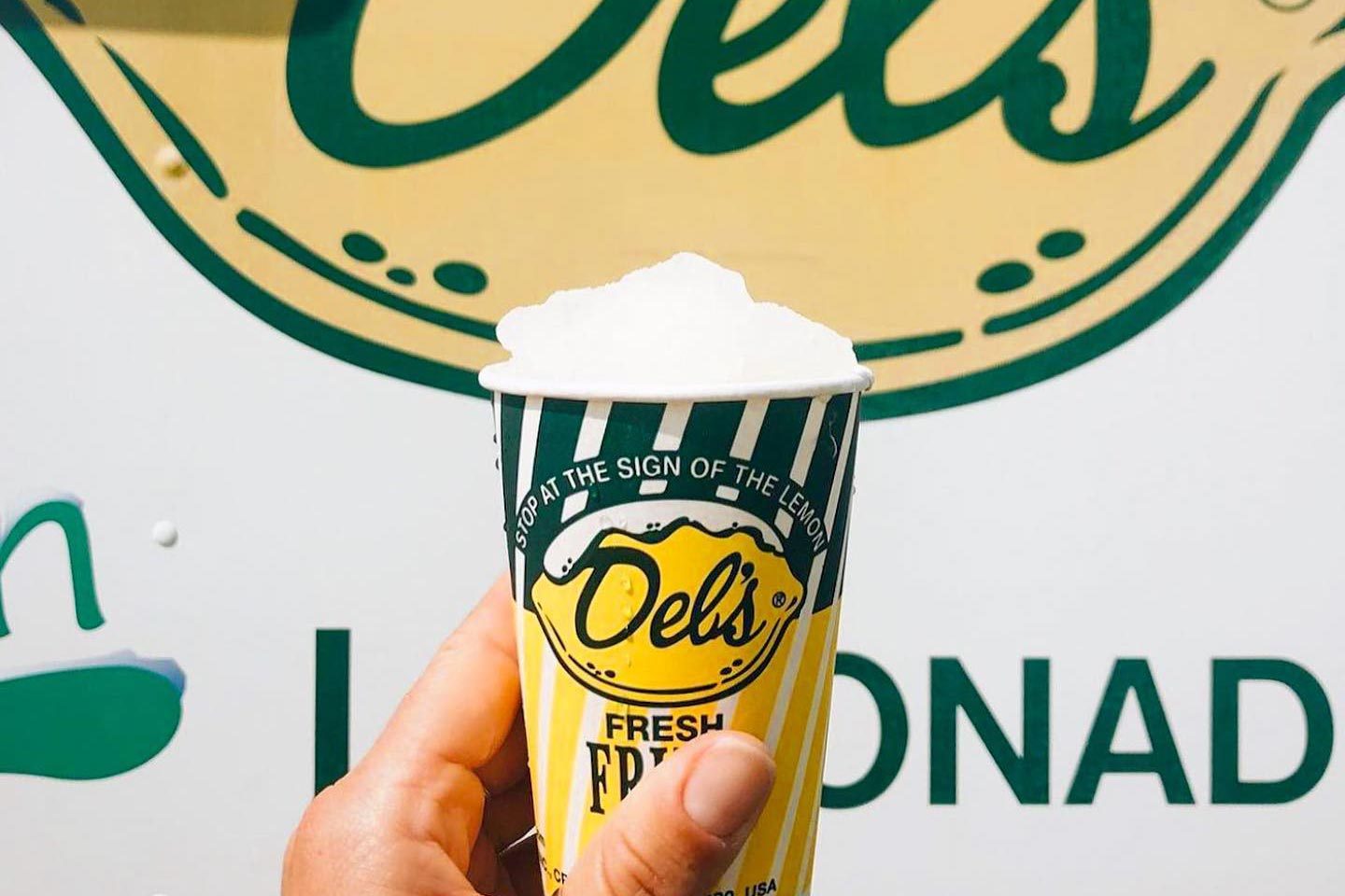 hand holding a Dels Frozen Lemonade cup