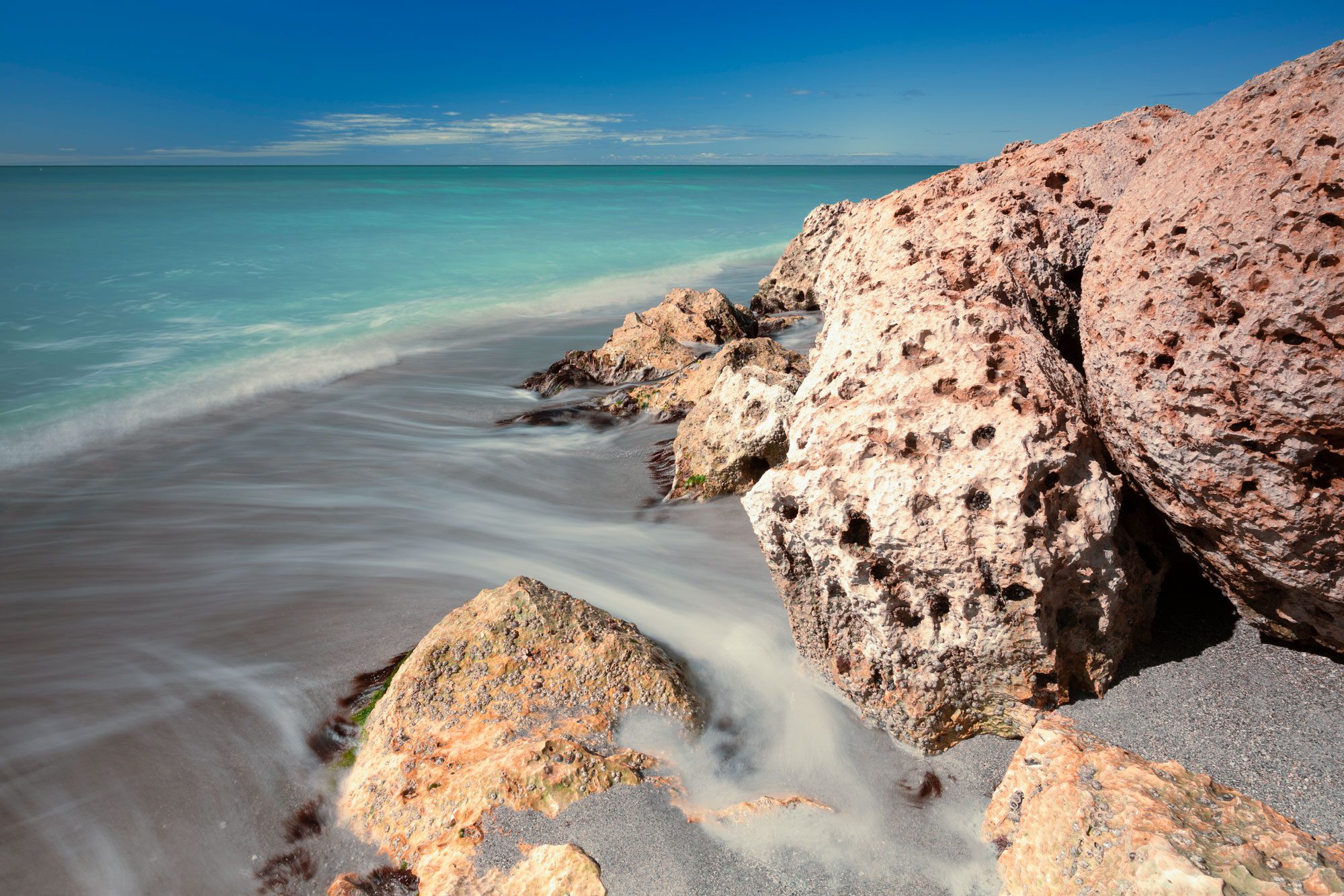 Waves run through rocks at Turner Beach on Captiva Island, Florida