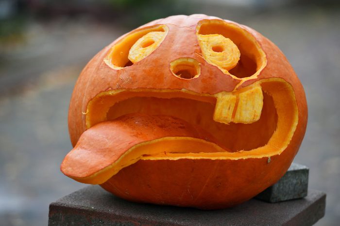 goofy face carved into a halloween pumpkin