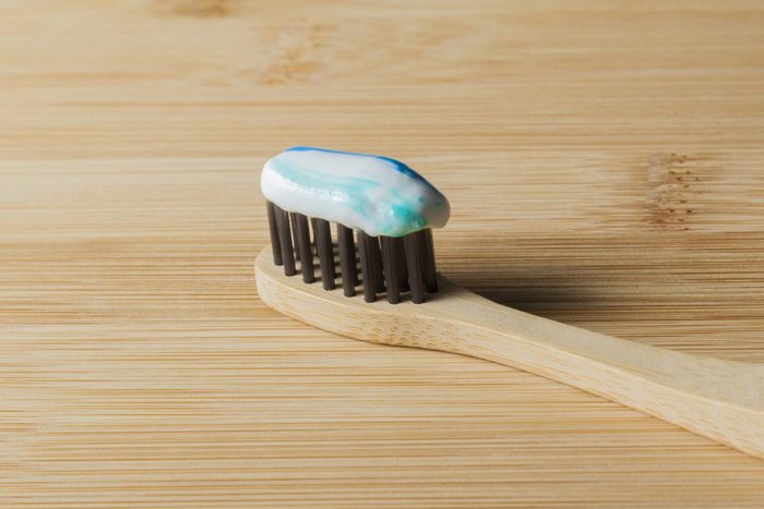 Toothbrush on the table with toothpaste.
