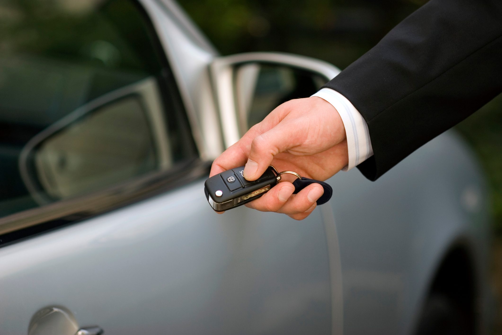 Person at car using remote control key, close-up