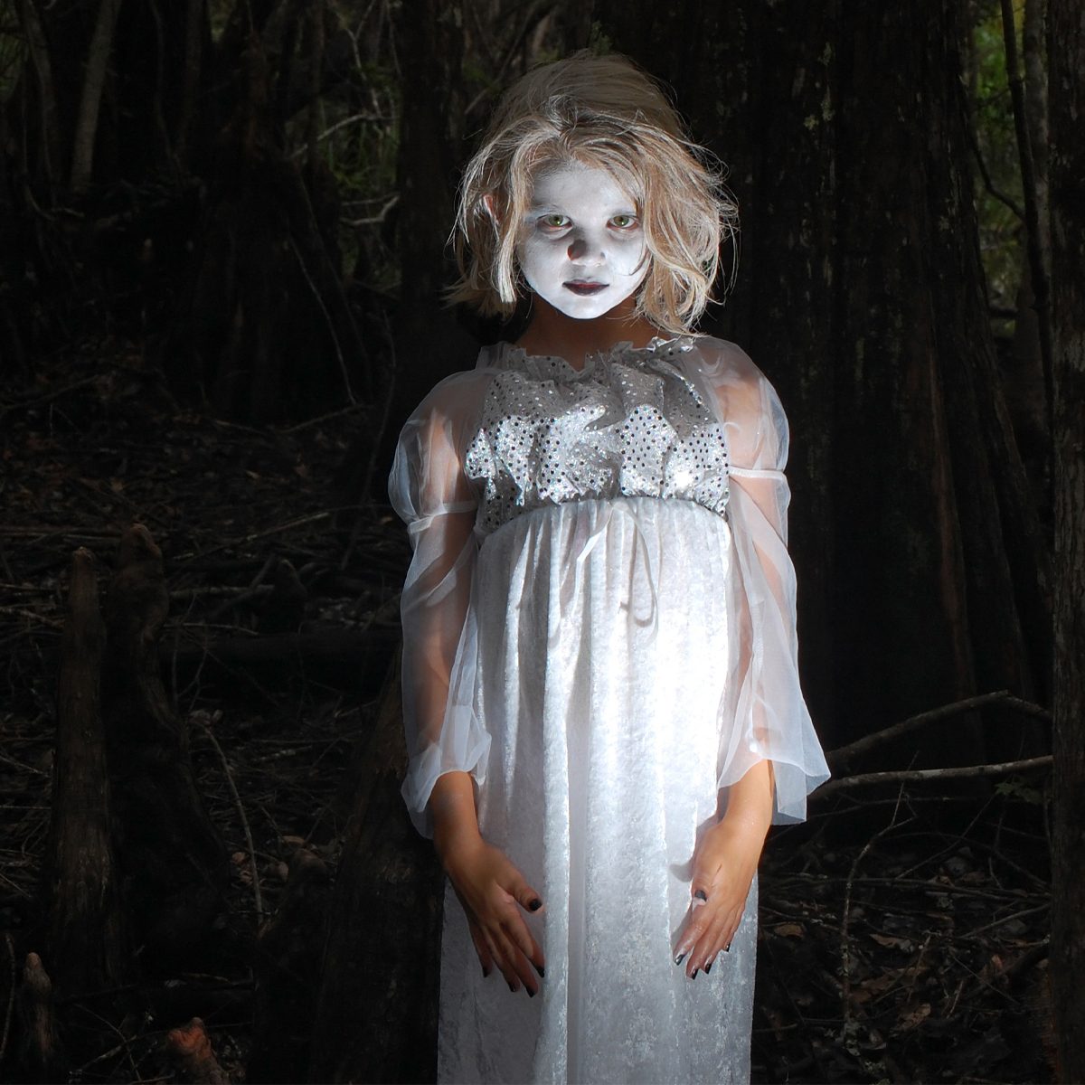 Gettyimages 172368515 A 7 Year Old Little Girl Dressed Up As A Ghoul Or Ghost Inside Of A Dark Creepy Cypress Swamp, Surrounded By Huge Cypress Roots Credits 