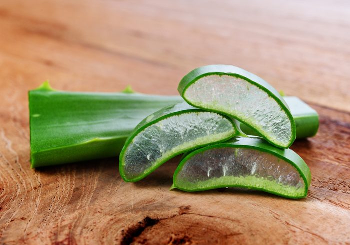 Aloe vera leaves on wooden background.