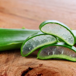 Aloe vera leaves on wooden background.