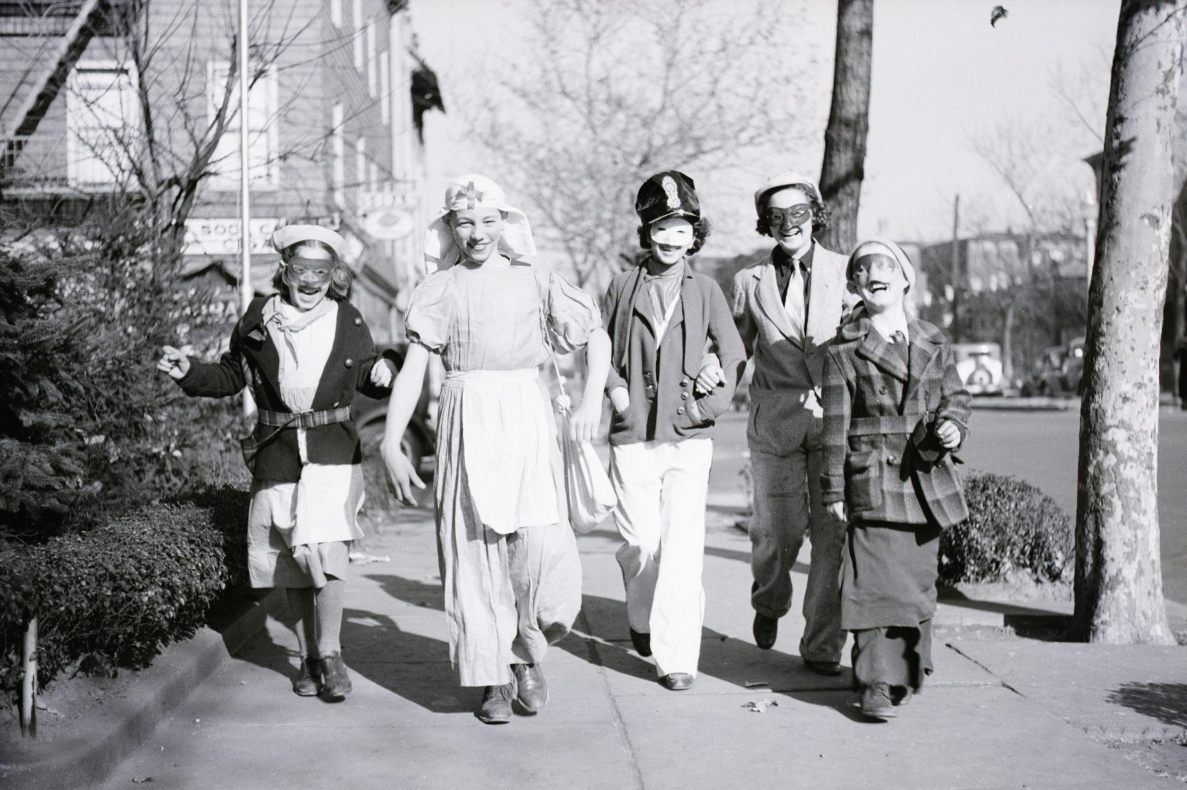 Children Dressed For Halloween walking down a sidewalk in jersey city, nj