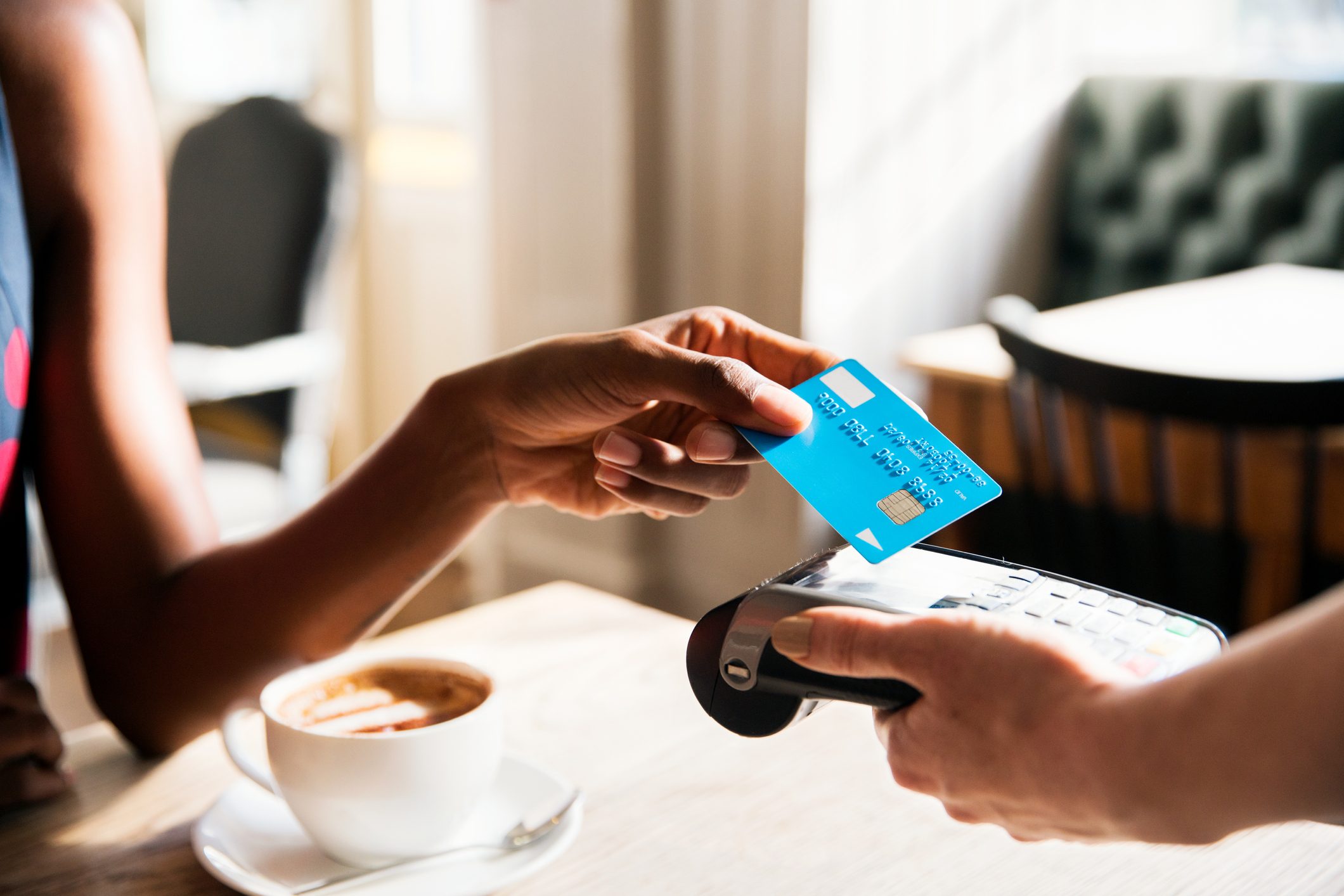 Woman using contactless payment with credit card