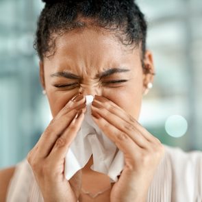 Woman sneezing