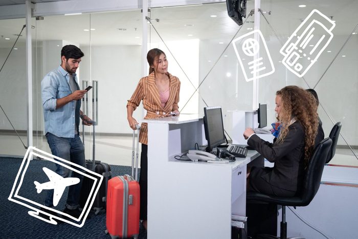 Airline passengers checking in at airline counter.