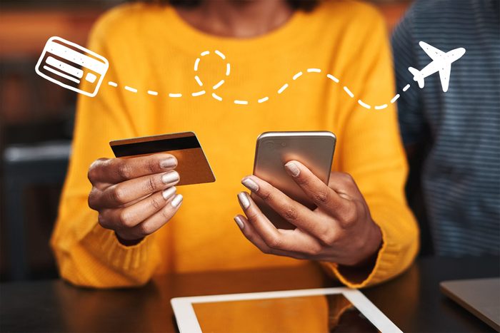 Woman in a cafe shopping online with credit card