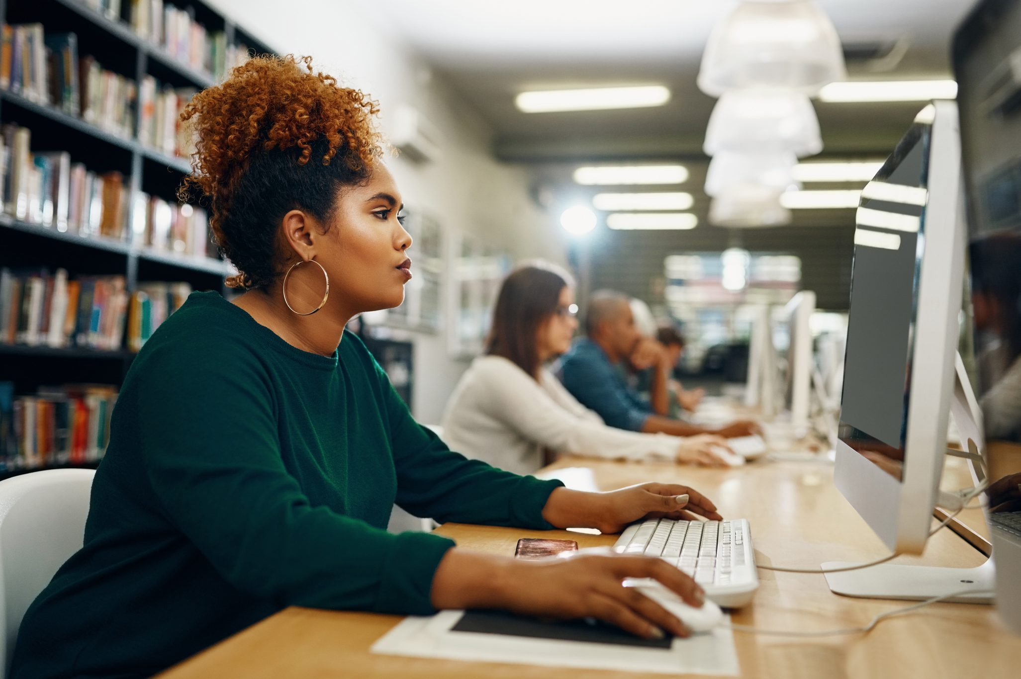 young woman working on public library computer